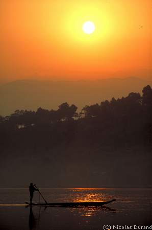 Paddling fisherman in Buon-Ma-Tuot at sunrise